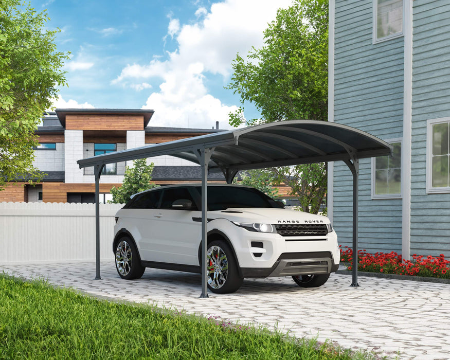 A white SUV parked under the Canopia Vitoria 5000 10x16 Carport with a clean, modern home as the backdrop.