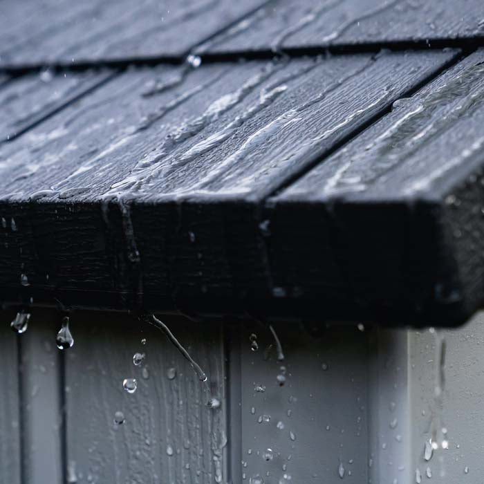 Water running off the roof of the Lifetime Classic 8x5 Outdoor Shed, demonstrating weather resistance.