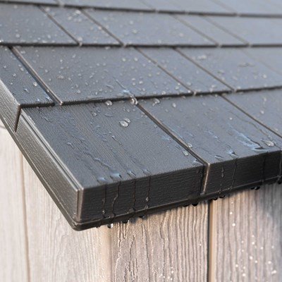 Close-up of the Lifetime storage shed's weather-resistant roof shingle detail with water droplets.