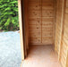 Spacious interior of GardenSaver 12x4 cedar shed with natural wood walls, plywood floor, and open doorway for easy access.