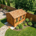 Side angle view of the Outdoor Living Today Space Master 8x12 western red cedar storage shed with double doors.