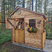 Western red cedar Sunshed 8x8 garden shed shown from a side angle, highlighting its wood siding and windowed doors.