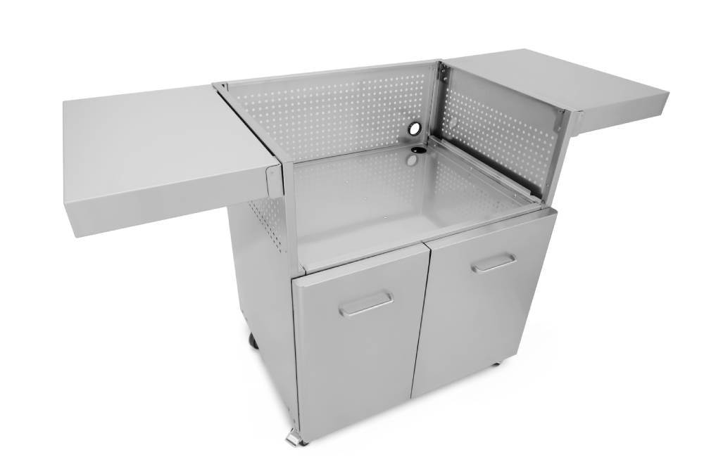 An angled view of the Wildfire Griddle Cart in stainless steel, showing the two fold-out side tables, double doors for storage, and the open top for griddle installation.