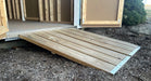 Wooden entry ramp attached to Ez-Fit Skyview Shed Kit providing easy access for lawn equipment and storage items.