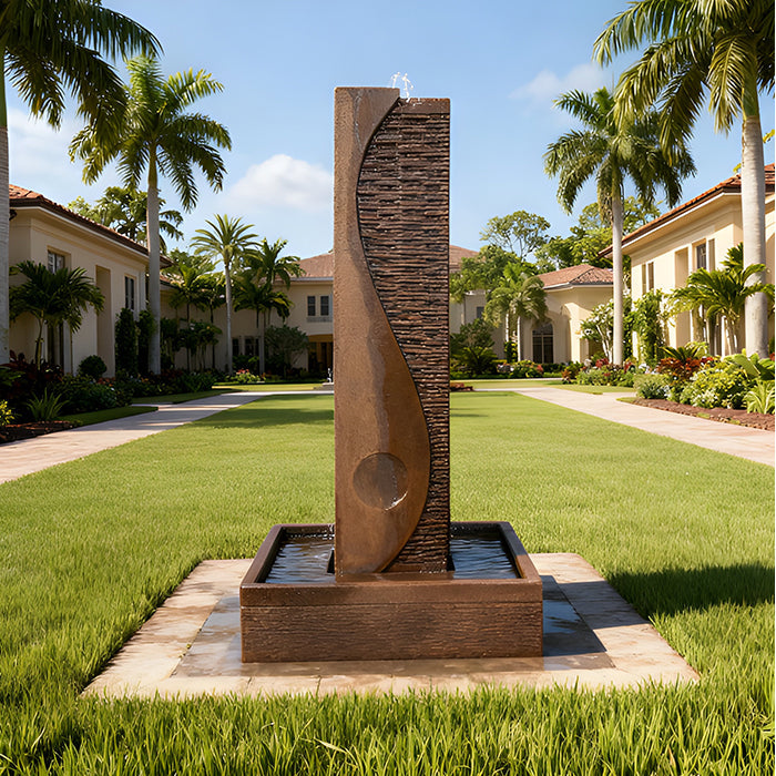 Brown stone Yang outdoor water fountain featuring curved textured design and square basin, styled in a luxury palm-lined courtyard.