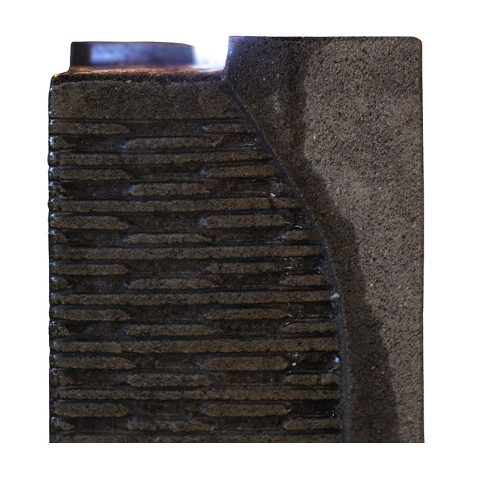 Detailed close up of Yang water fountain textured stone panel with visible water flow and smooth curved accent design.
