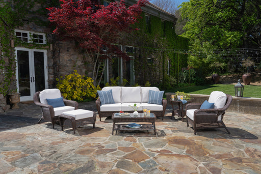 An outdoor living space with a Tortuga Outdoor Sea Pines 6-Piece Outdoor Wicker Sofa Set - Java.