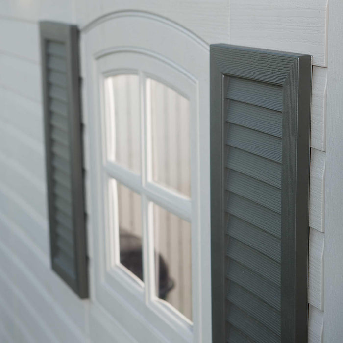 Window and shutter details outside of a utility shed