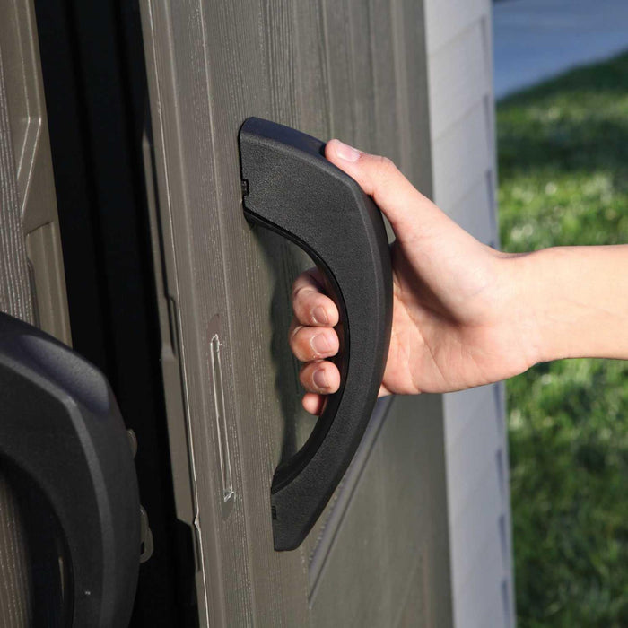 A person opening the door handle of a Storage Shed