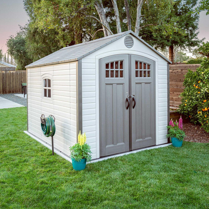 A shed placed on a backyard placed with decorations