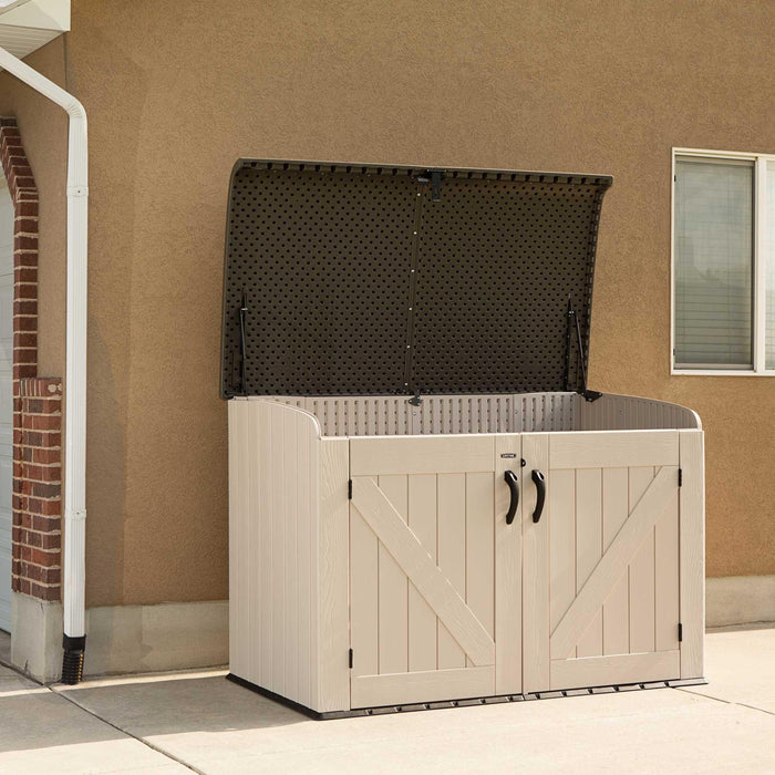 A Lifetime Horizontal Storage Shed (75 Cubic Feet) - 60170 sitting outside of a house.
