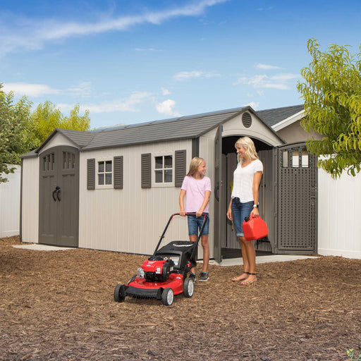 Two women standing in front of a 17.5 Ft. X 8 Ft. Storage Shed from Lifetime