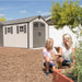 A woman and a girl planting a garden in front of an Outdoor Storage Shed  manufactured by Lifetime.