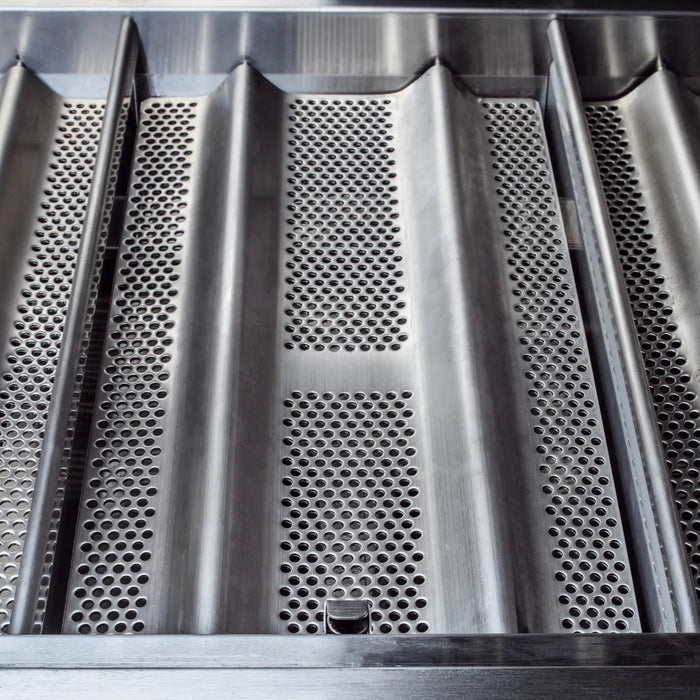 Detailed image of the gas grill's cooking surface, highlighting the perforated heat zone separators between the grates.