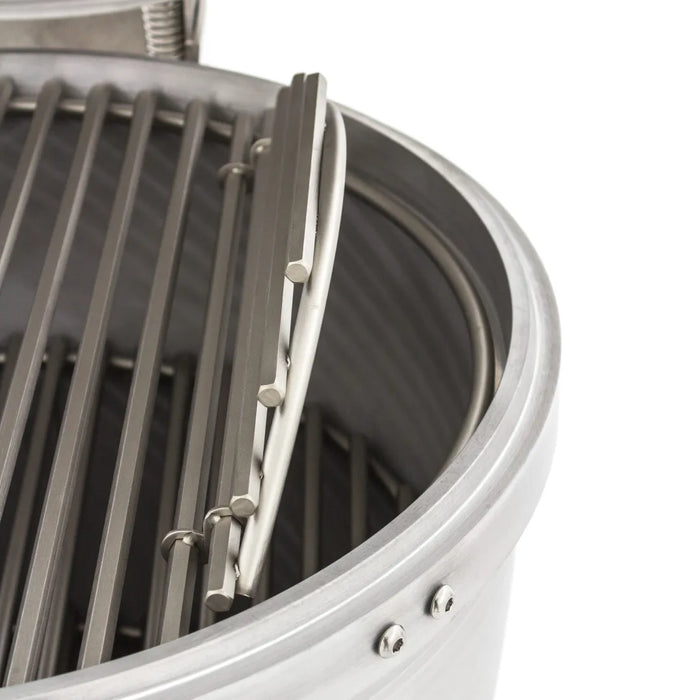 Close-up of the hinged cooking grates on the Blaze Grills 20-Inch Cast Aluminum Kamado Grill, showcasing the flip-up sections for easy access to the coal beneath.