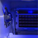 The inside of the Blaze Grills Outdoor Ice Maker illuminated with a blue light, enhancing visibility of the ice grid and scoop.