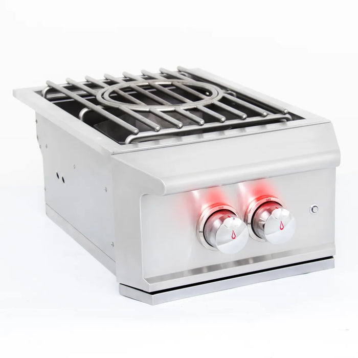 An angled view of the Blaze Grills Professional built-in power burner with illuminated red control knobs.