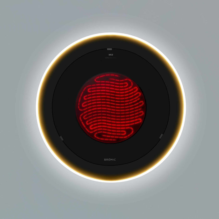 A detailed overhead view of the heating element of Bromic's Eclipse 2900 Watt electric heater, glowing red surrounded by a golden halo.