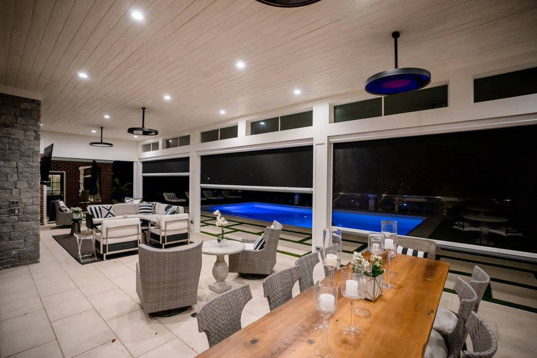 Luxurious patio with a poolside view under the warmth of the Bromic Smart-Heat Eclipse Electric 2900W Heater with integrated light.
