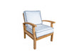 A Tortuga Outdoor luxury retreat teak lounge chair with a blue cushion.