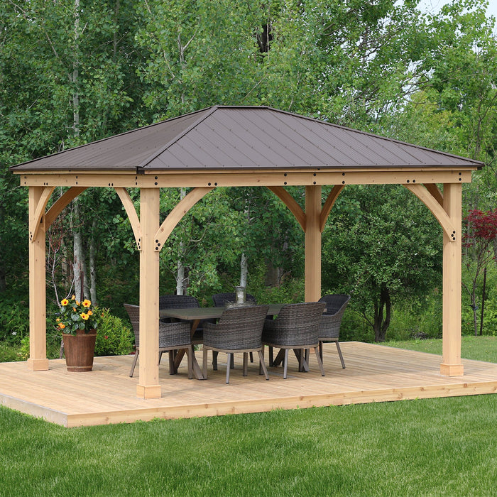 A Yardistry Meridian Premium Cedar Gazebo with a table and chairs on a wooden deck.