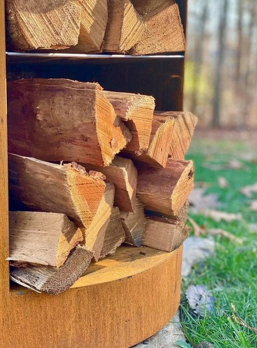 Close up photo of logs inside the tall base storage of the Arteflame Classic 40" Grill.