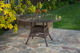 The dining table from the Tortuga Outdoor Sea Pines 5-Piece Outdoor Wicker Dining Set - Java on a patio.