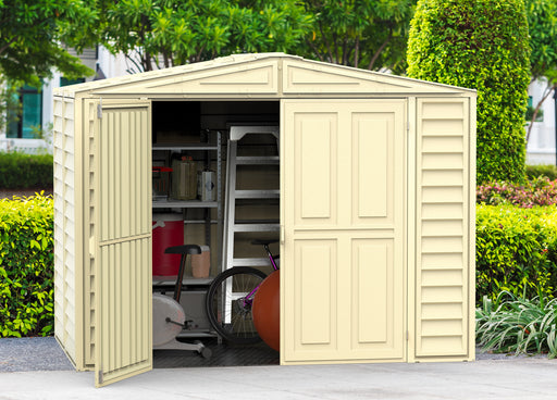 Duramax Duramate 8x5.3 Vinyl Shed w/ Foundation placed outdoors one door open, with things inside