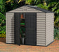 A Duramax StoreMax Plus 10.5 X 8 - 30225 storage shed with a door open. placed outside; door slightly open with things inside