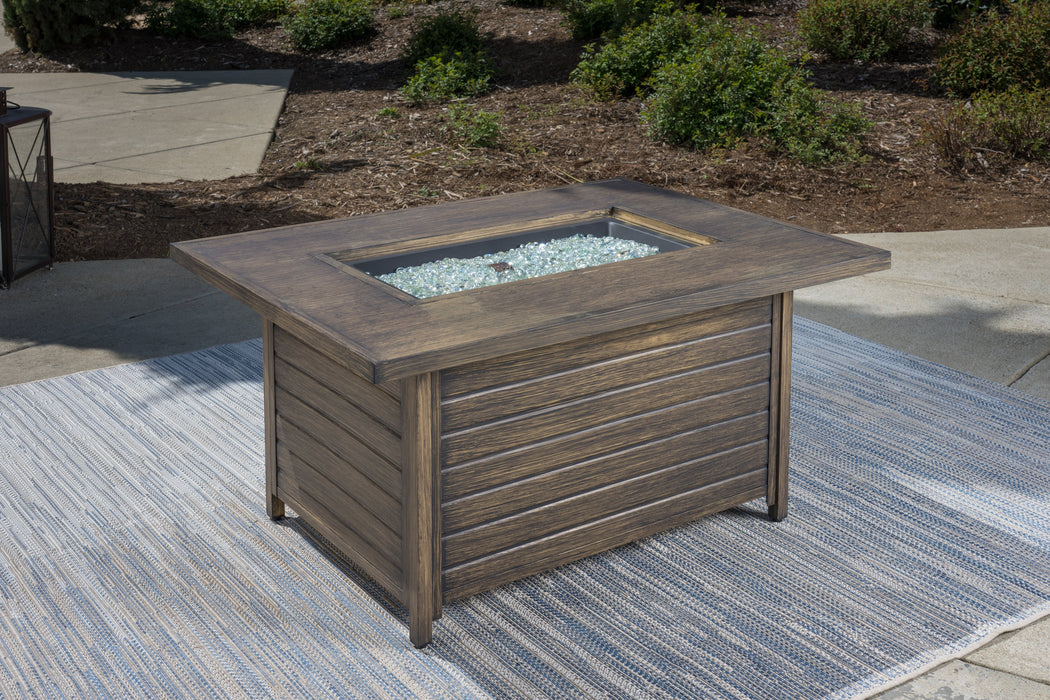 A luxurious Tortuga Outdoor fire pit with a glass top on a patio.