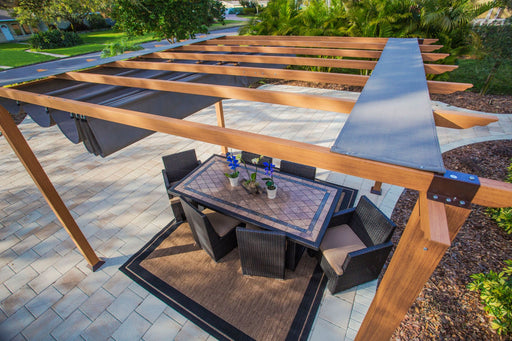 An overhead view of the Florence Aluminum Pergola with a fabric canopy providing shade over an outdoor dining set