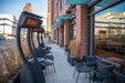 Bromic Tungsten 500 Series portable gas patio heaters lined up outside an urban cafe, providing a warm outdoor seating area.