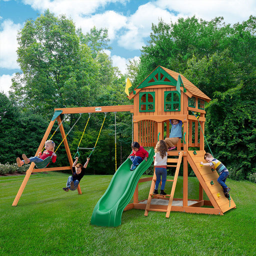Children playing on the Swing Set with wood treehouse roof, featuring swings and a slide.