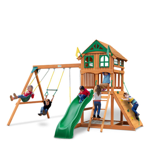 Children actively playing on the Gorilla Outing Swing Set with wood roof, swings, and tube slide.