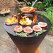 A versatile grilling accessory, the Arteflame grate riser, holding meats and vegetables over flames.