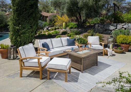 The Tortuga Outdoor 6-Piece Indonesian Teak Sofa and Fire Table Set - Canvas Natural or Navy is the epitome of luxury retreat for your patio. This exquisite patio furniture set by Tortuga Outdoor includes a table and chairs, providing both style and comfort.