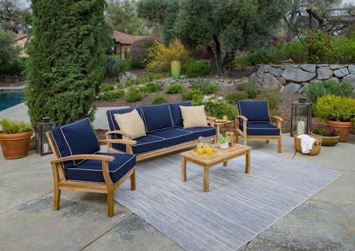 A durable construction Tortuga Outdoor 5-Piece Indonesian Teak Sofa Set - Sunbrella Canvas Natural or Navy with blue cushions.