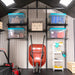 A garage with a Lifetime 11 Ft. X 11 Ft. Outdoor Storage Shed - 6433 and storage bins.