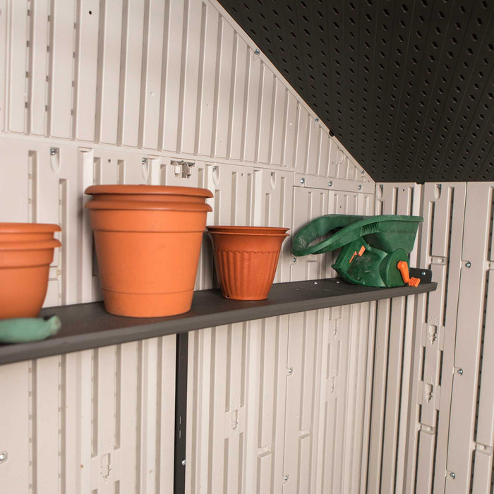 A shelf with Lifetime 8 Ft. X 10 Ft. Outdoor Storage Shed - 60332 and gardening tools.