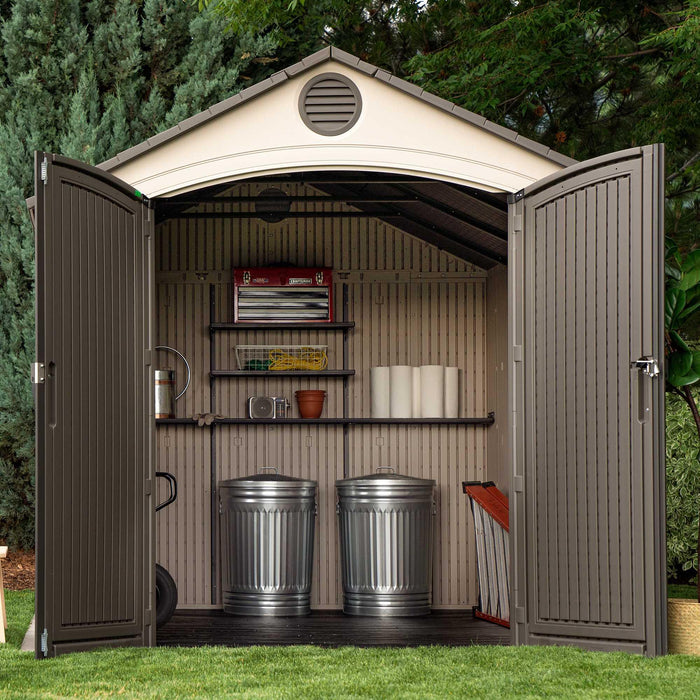 A Lifetime 8 Ft. X 12.5 Ft. Outdoor Storage Shed - 6402 with a door open and a trash can.