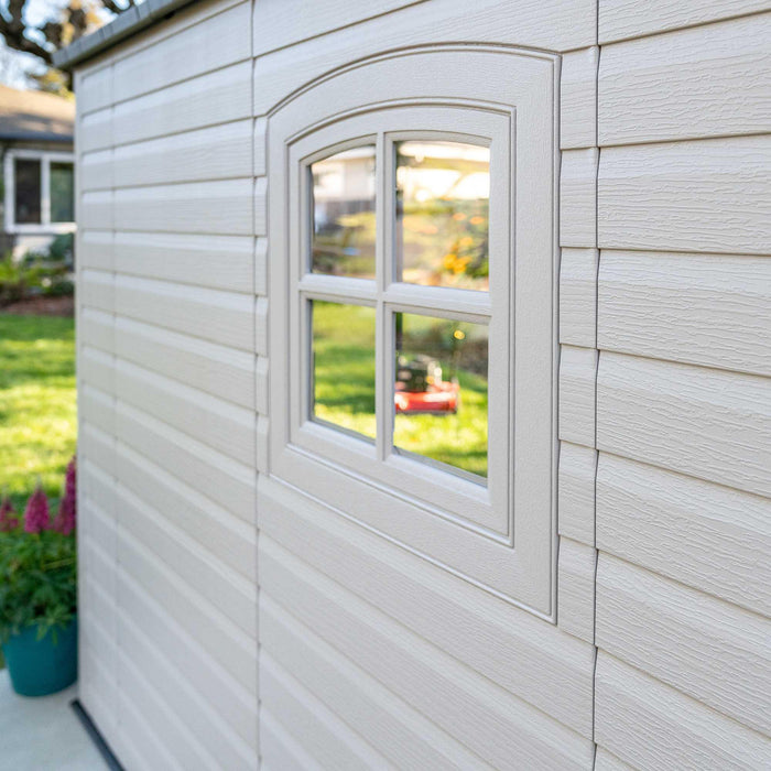 A Lifetime 8 Ft. X 15 Ft. Outdoor Storage Shed - 60075 with a window in it.