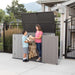 A woman and a child standing next to a Lifetime Horizontal Storage Shed - 60296U.