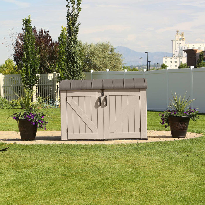 A Lifetime Horizontal Storage Shed (75 Cubic Feet) - 60170 in the middle of a grassy area.