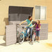 A woman and a girl getting their bicycles from the Lifetime Horizontal Storage Shed (75 Cubic Feet) - 60170.