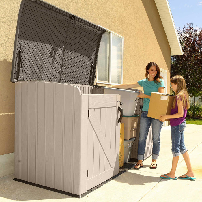 A Lifetime Horizontal Storage Shed (75 Cubic Feet) - 60170 with mother and daughter putting boxes