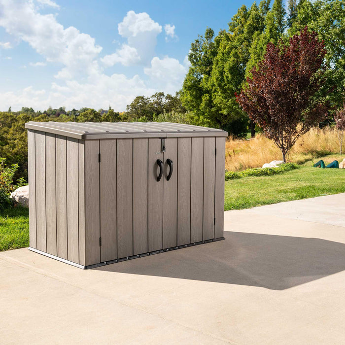 A Lifetime Horizontal Storage Shed (75 Cubic Feet) - 60341 sitting on a concrete patio.