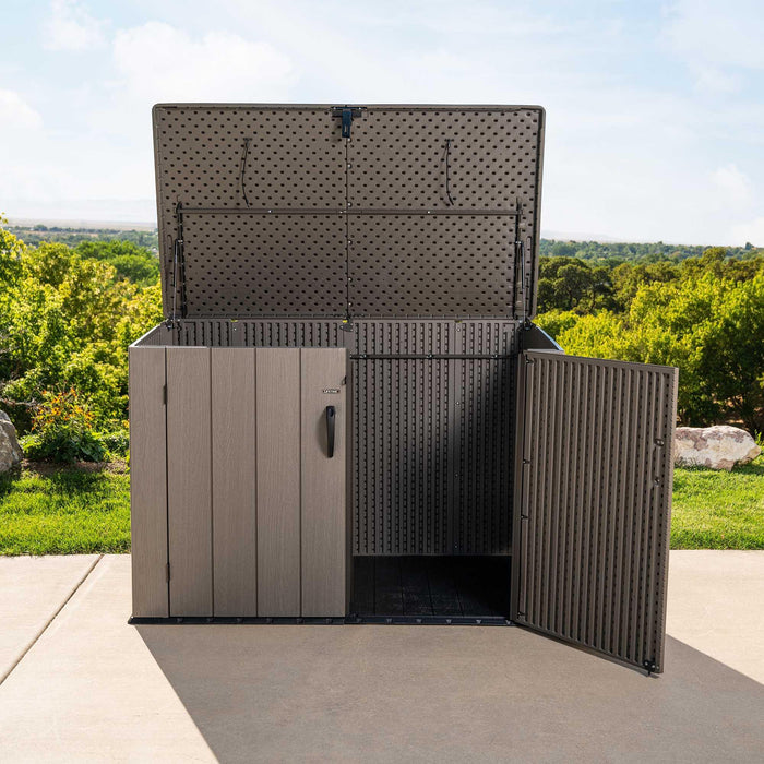 A Lifetime Horizontal Storage Shed (75 Cubic Feet) - 60341 sitting on a grassy area.