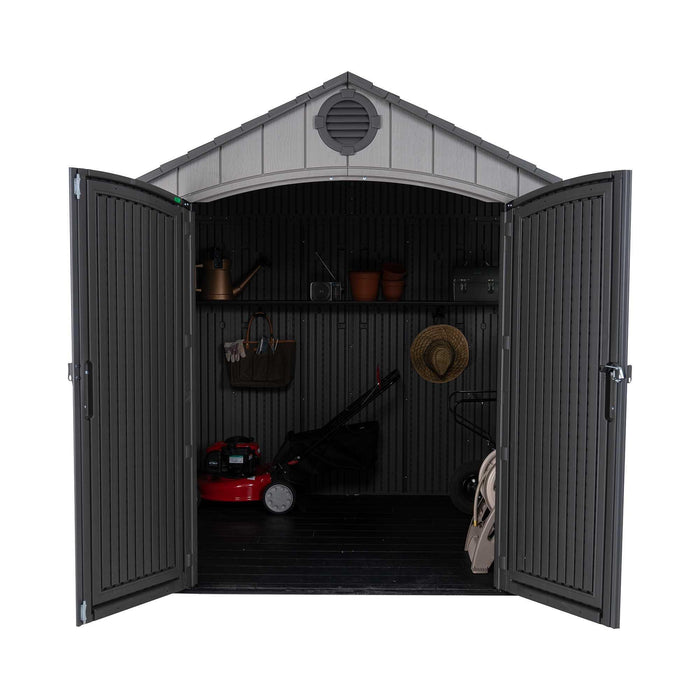 Front view of a storage shed featuring items inside the shed 