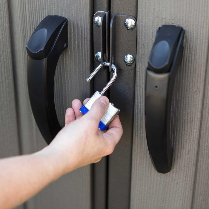 A person unlocking a door for a storage shed