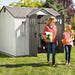 A woman and a girl standing in front of a Lifetime 10 Ft. X 8 Ft. Outdoor Storage Shed - 60243.